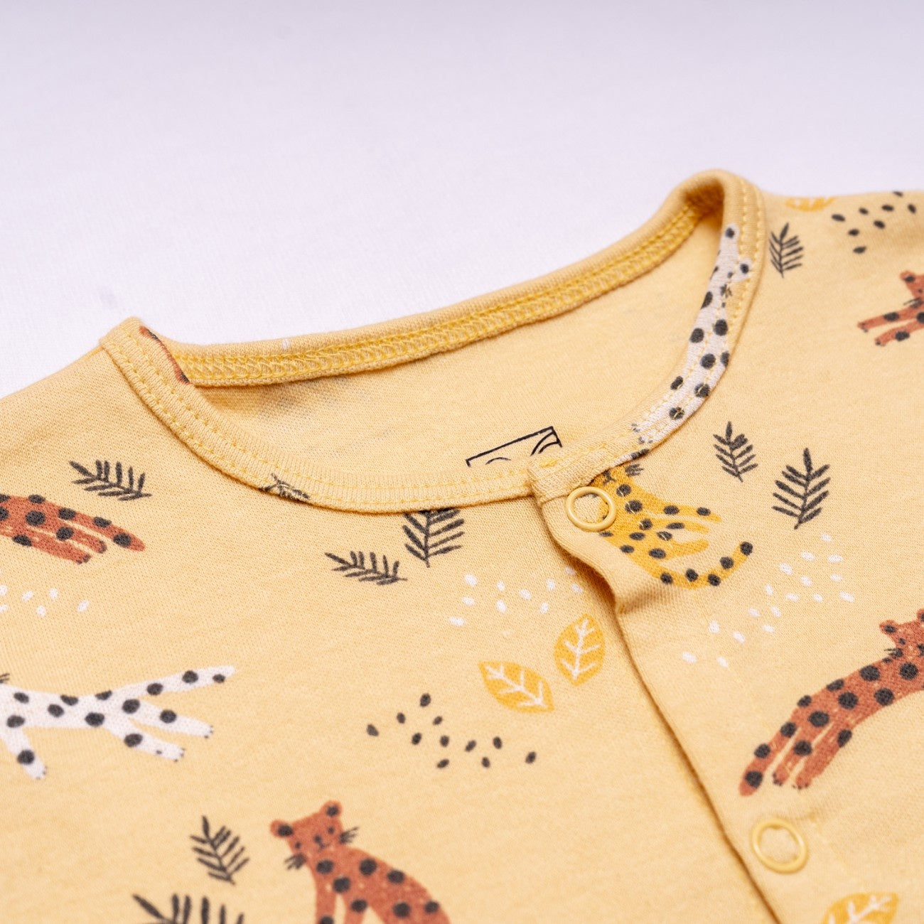 cheetah printed cotton baby clothing set closeup